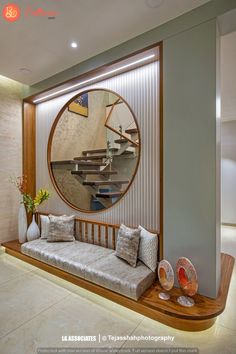 a living room filled with furniture and a round mirror