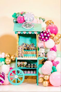 an ice cream cart with balloons and decorations