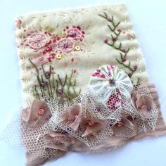 a close up of a piece of cloth with flowers on it and lace around the edges