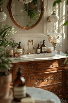 a bathroom with a sink, mirror and potted plants on the counter top in front of it