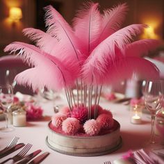 the centerpieces are adorned with pink feathers and pom - poms