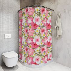 a shower curtain with pink and white flowers on it next to a toilet in a bathroom