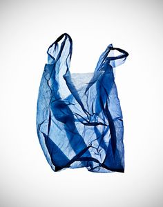 a blue bag is hanging upside down on the ground with it's fabric pulled back