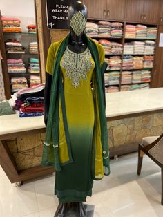 A stunningly fabulous outfit, featuring Kashmiri Tilla Embroidery. - - - - - - - - - - - - - - - - - - - - Product Details- Condition: Brand New- Style: Indian Ethnic Suit- Colour: Ombre Light & Dark Green- Embroidery Color: Dull Gold- Care Instructions: Dry Clean OnlyF A B R I CShirt: Viscose GeorgetteDupatta: ChiffonLower: Indian CrepeF I N I S HUnstitched/Semi-StitchedYou can get it stitched locally.47+ inches of Shirt Length and up to full sleeves length.StitchedWant something ready to w Pista Green Dori Work Kurta In Dola Silk, Pista Green Dola Silk Kurta With Dori Work, Pista Green Raw Silk Salwar Kameez With Dori Work, Pista Green Kundan Sets For Eid, Pista Green Straight Kurta Churidar In Dola Silk, Green Raw Silk Churidar With Dori Work, Green Churidar With Chikankari Embroidery In Art Silk, Pista Green Chinon Sets With Traditional Drape, Green Art Silk Churidar With Chikankari Embroidery