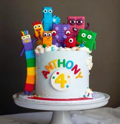 there is a birthday cake decorated with cartoon characters on it and the number four in front