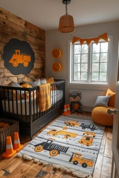 a child's bedroom with construction themed decor and orange accents on the walls, along with a crib