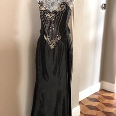 Jessica Mcclintock's Evening Two-Piece Bustier Dress Is Made Of Heavy Black Silk. The Top Has A V Shape, And Gold Beading In Front, Is Sleeveless, And Has A Back Zipper. The Skirt Features Four Wide Wedges Starting From The Middle To The Floor. It's Only Been Worn Once And Is In Like-New Condition. The Top Has Been Professionally Adjusted For A Great Fit. Bustier Measurements: Top To Bottom Sides 9.5”, Front 12.5”, Armpit To Armpit 18". Skirt Measurements: 16” Waist, 21” Midsize, 41.5” Length. Dress Two Pieces, Jessica Mcclintock Dress, Skirt Measurements, Jessica Mcclintock, Bustier Dress, Black Silk, V Shape, Two Pieces, Evening Dress