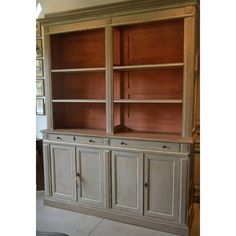 a large bookcase with two doors and drawers