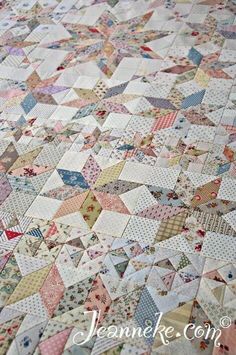 an old quilt is laying on the floor