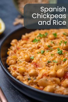 spanish chickpeas and rice in a skillet with chopsticks on the side