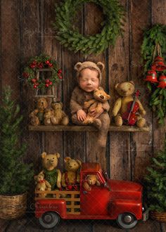 a baby in a teddy bear outfit is sitting on a shelf with christmas wreaths