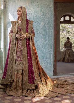 a woman in a bridal gown standing on the floor