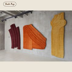 three pieces of wood are hanging on the wall