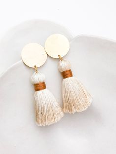 "A bolder earring, the Statement Tassels are perfect for the minimalist who wants to be seen. The elegant tassel wrapped in a Caramel binding, hangs from a large 1\" raw brass stud disc. A both a statement and clean version of the common dangle tassel earrings. I love the simplicity and the confidence boost they give to any look. This listing is for a pair of Statement Tassel stud earrings. I offer multiple color WRAPS, choose from the drop down variation menu when ordering. (I can also accommod Kids Wooden Toys, Bold Earrings, Tiny Earrings, Confidence Boost, Earrings Photo, Multiple Color, Etsy Fashion, Raw Brass, Star Earrings