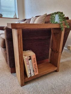 a wooden shelf with books on top of it in the middle of a living room