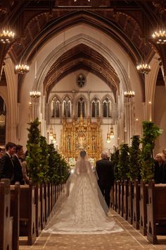 a bride and groom are walking down the aisle at their wedding ceremony in an old church