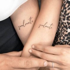 two people holding hands with tattoos on their arms that say, soulmate and ultimate