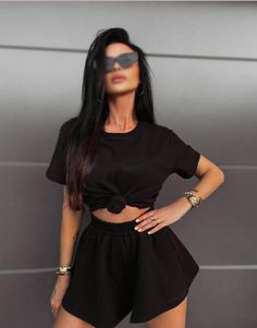 Unveil your style with this sophisticated black outfit. Featuring a chic knotted crop top and ultra-comfortable high-waisted shorts, this ensemble effortlessly combines fashion and comfort. Ideal for every casual outing or laid-back gathering, this versatile set will elevate your wardrobe. Available in various sizes to fit every body type, this must-have outfit ensures you step out in confidence and charm. Casual Two-piece Set Crop Top, Short Sleeve Two-piece Crop Top, Black Two-piece Set For Summer, Black Two-piece Crop Top For Summer, Summer Black Two-piece Crop Top, Casual Black Short Set For Summer, Black Short Sleeve Crop Top For Loungewear, Casual Cropped Sets For Night Out, Casual Black Short Set