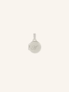 Keep your loved ones close to your heart with our Engravable Round Locket Pendant. Available in small, medium, and large sizes, you can personalize this beautiful locket with a special message or initials. Carry a cherished memory with you wherever you go. Elegant Silver Initial Pendant Locket Necklace, Elegant Silver Locket Necklace With Initial Pendant, Classic Engraved White Gold Locket Necklace, Elegant Locket Necklace With Engraving Option, Luxury Engraved Locket Necklace For Keepsake, Personalized Heirloom Locket Necklace For Memorial, Heirloom Personalized Locket Necklace For Memorial, Silver Engraved Initial Pendant Locket, Silver Engraved Initial Pendant Locket Necklace