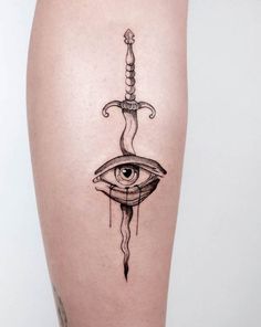 a woman's leg with a tattoo on it and an eye in the middle