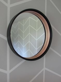 a round mirror hanging on the wall