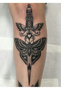 a tattoo on the leg of a person with a knife in it's hand