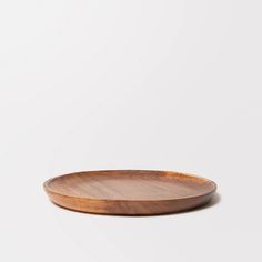 a wooden plate sitting on top of a white table