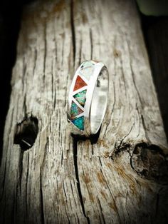 Want this inlaid with different gemstones? Please message me about doing a custom Order 925 Sterling Silver Opal Ring Sterling silver Navajo designed and revived ring inlaid with the Red, Green, White, Blue and Pink opals. Width of ring face: 1/4 of an inch tall. Weight: A Size 11 is 6.8 grams, weight varies for ring size. Silver Opal Ring With Inlay, Bohemian Inlay Jewelry For Anniversary, Silver Opal Ring With Inlay For Anniversary, Anniversary Silver Opal Ring With Inlay, Wedding Ring With Inlay Jewelry, Bohemian Multi-stone Opal Anniversary Ring, Unique Sterling Silver Opal Inlay Ring, Unique Sterling Silver Opal Ring With Inlay, Silver Opal Ring With Inlay For Gift