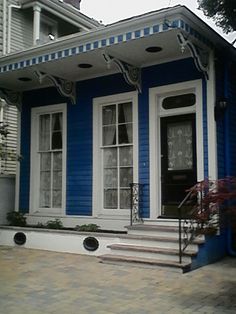 a blue and white house with steps leading up to it