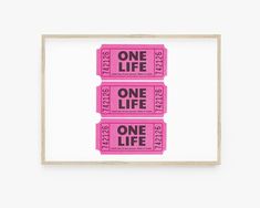 two pink tickets with the words one life printed on them in black and white ink