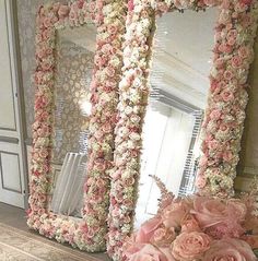 there is a large mirror with flowers on it