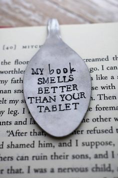 a book page with a spoon on it that says, my book smells better than your table