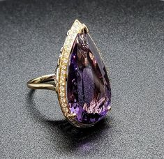 14k solid yellow & white gold ring with 0.60 ct. SI1, G color natural brilliant diamonds & 19.20 ct. 26x15 mm pear shape natural AAA amethyst. This item can also be ordered in white, rose or any other color gold combination with different color gemstones such as, blue topaz, London blue topaz, green amethyst, pink amethyst, citrine, garnet, smoky quartz, white topaz, aquamarine, peridot & morganite. Please contact me for a quote as each gemstone varies in price. Please don't hesitate Formal Teardrop Amethyst Ring In Fine Jewelry Style, Elegant Teardrop Amethyst Ring For Formal Occasions, Formal Teardrop Amethyst Ring, Elegant Pear-shaped Amethyst Ring, Elegant Pear-shaped Amethyst Ring For Formal Occasions, Elegant Formal Pear-shaped Amethyst Ring, Pink Amethyst, Green Amethyst, London Blue Topaz