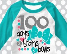 a white and turquoise shirt with bows on the front that says 100 days, brains & bows