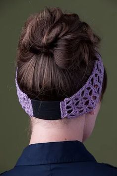 a woman wearing a purple crochet headband with a black ribbon around it