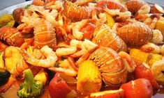 a plate full of cooked seafood and vegetables