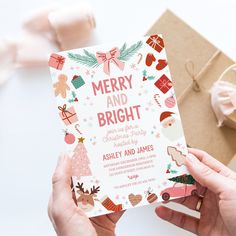 two hands holding up a merry and bright christmas party card next to some wrapping paper