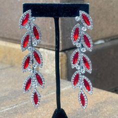 style: Crystal Rhinestone Floral  Vine Marquise Dangle Earrings  color: red & clear rhinestones on silver  Length: 3 3/4" Width: 7/8" Hypoallergenic Stainless Steel Post circle pushback closure Red Chandelier Earrings For Formal Events, Formal Red Chandelier Earrings, Red Crystal Drop Earrings, Glamorous Red Drop Earrings, Red Jewelry With Earrings For Evening, Red Crystal Drop Earrings For Pierced Ears, Red Dangle Bridal Earrings, Red Drop Earrings For Evening, Red Chandelier Earrings For Party