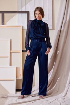 Slip into our Satin Pleated Pants. With front pleats and a removable satin belt, the unique patina and meticulous fit make these pants a standout. Pair them with our Satin Draped neck top or Matte Jersey Knit for a monotone column of refined style.     Elie Tahari Exclusive    Satin Wide Leg Pleated Pant with Self Belt    80% Acetate, 20% Polyester    Runs true to Size    Measurements: 13.5"L Front Rise, 33"L Inseam (approx. length for a size 6)    Model is 5'9" and wearing size 2    Dry Clean O Luxury Satin Pants For Work, Luxury Satin Pants For Workwear, Chic Silk Wide Leg Pants For Work, Evening Wide Leg Belted Bottoms, Elegant High Waist Belted Wide Leg Pants, Chic Tapered-leg Pants With Belt, Chic Tapered Leg Pants With Belt, Elegant Silk Bottoms With Belt Loops, Elegant Belted Evening Bottoms