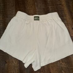 Size M/L Great Condition - Never Worn! I Just Ordered The Wrong Size. White Cotton Bottoms For Daywear, White Relaxed Fit Bermuda Shorts, White Cotton Bottoms With Built-in Shorts, Casual White Bottoms With Elastic Waistband, Casual White Shorts, Sporty Cream Bottoms For Summer, Sporty Cream Shorts For Summer, White Sporty High-waisted Shorts, Sporty White High-waisted Shorts