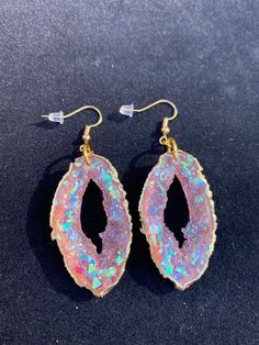 These pink opal geode inspired earrings are sure to get compliments or make an amazing one of a kind gift!  They are lightweight because they are made from resin and won't weigh down your ears. Please choose whether you would like gold or silver earwires, and the edges can be painted in a beautiful gold or silver metallic Clip on earrings are available as well Handmade by Katie  KG Design & Decor Please follow my on social media  Instagram: @KG_DesignandDecor Facebook: KG Design and Decor Please Agate Drop Earrings Gift, Agate Drop Earrings For Gift, Agate Drop Earrings As A Gift, Pink Resin Dangle Jewelry, Handmade Opal Drop Earrings, Iridescent Pierced Drop Earrings, Pierced Iridescent Jewelry For Party, Iridescent Pierced Jewelry For Party, Iridescent Resin Drop Earrings