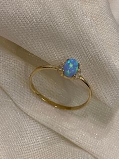 "ABOUT PRODUCT This 14K Gold Opal Ring is beautifully designed and hand crafted with our associates to make this a special gift for your loved ones. Knowing the value of our customers, We prepare each piece with extra care and attention.  ITEM DETAILS Material: 14K Gold Approx:  1.36 gram Available colors: Gold, Rose Gold, White Gold Available Sizes: 4 US to 11 US  ✪ 14k Solid Gold ( Certification will be included with your order ) ✪Available 14K White, Yellow, Rose Gold (also in 10, 18K) 🛠 Yaz Minimalist Jewelry Gold, Dainty Opal Ring, Oval Opal Ring, 14k Gold Opal Ring, Gold Opal Ring, Schmuck Gold, Cute Gifts For Her, Gold Rings Stackable, Zierlicher Ring