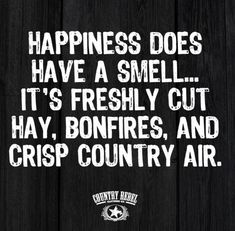 a sign that says happiness does have a smell it's freshly cut hay, bonfires, and crisp country air