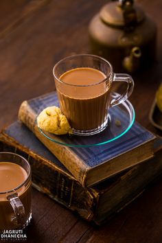 a cup of coffee sitting on top of a book