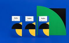 three books are sitting next to each other on a blue background with green and yellow shapes