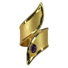 Luxury Gold Amethyst Ring Gift, Gold Amethyst Open Ring Fine Jewelry, Modern Gold Amethyst Gemstone Ring, Elegant Yellow Gold Amethyst Open Ring, Luxury Gold Amethyst Ring For Anniversary, Modern Gold Amethyst Ring With Oval Shape, Modern Gold Oval Amethyst Ring, Elegant Wide Band Ring With Gemstone For Gift, Luxury Wide Band Oval Ring With Polished Finish