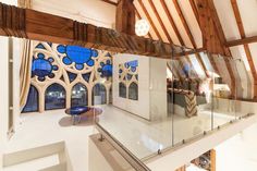 the inside of a building with wooden beams and glass railings on top of it