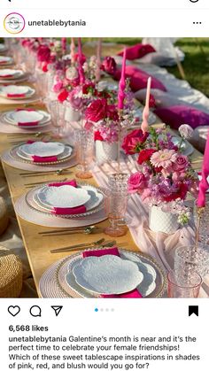 the table is set with pink and white plates, silverware, and flowers in vases