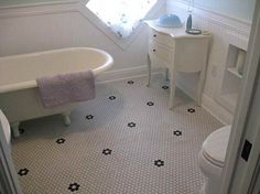 a bathroom with a sink, toilet and bathtub in the corner next to a window