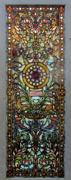 an ornate stained glass window on the side of a building